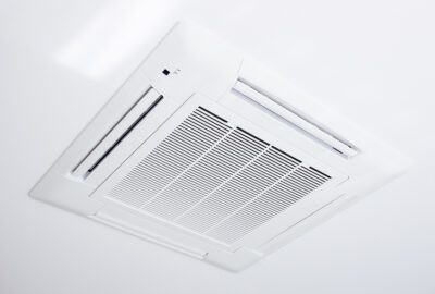 The indoor component of the ductless system mounted to the ceiling.